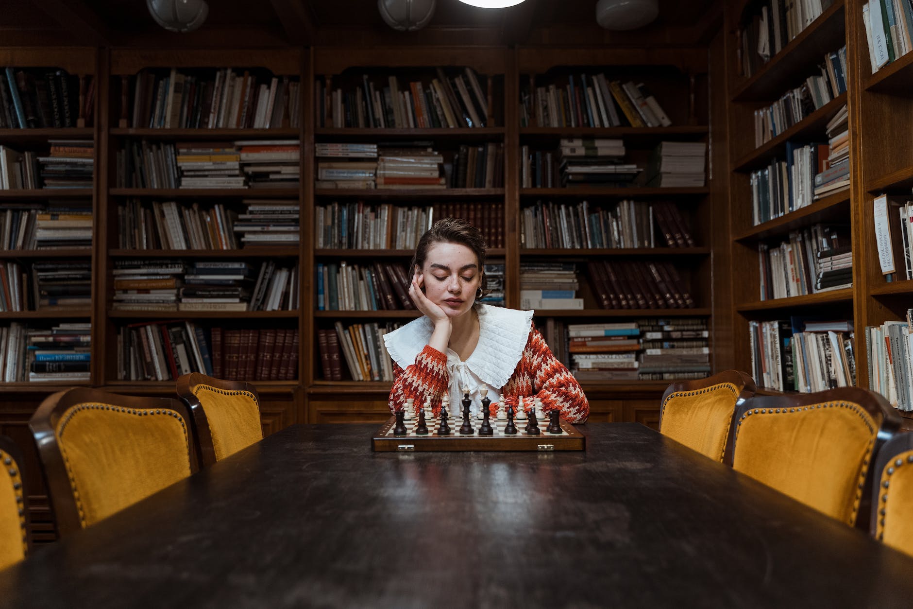 pensive woman playing chess