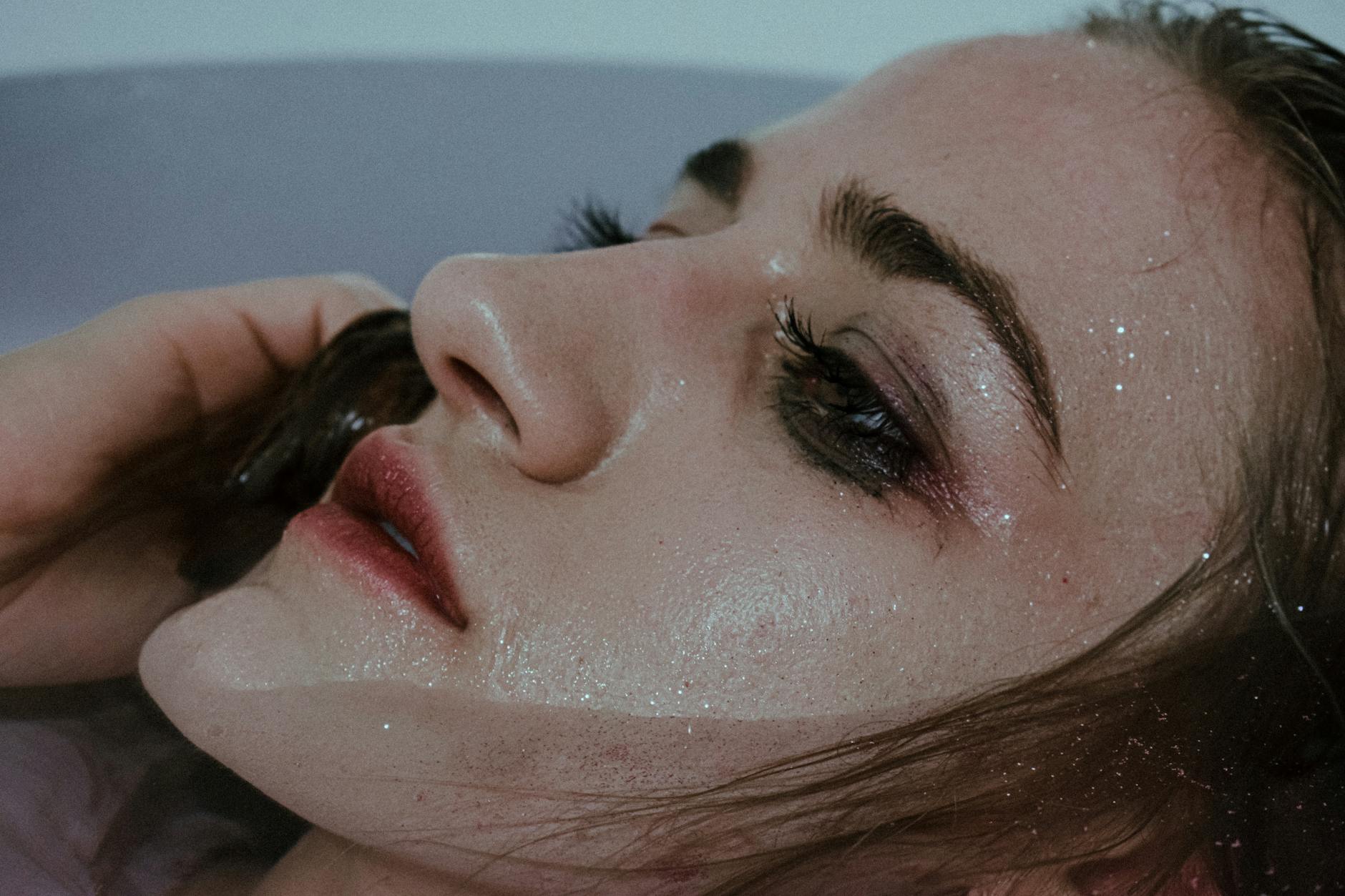 unemotional woman with smeared makeup in bathtub
